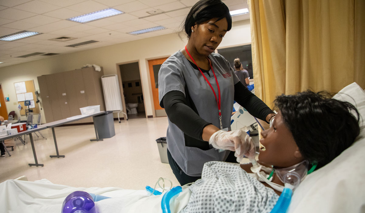 YVC Nursing student treats a test patient during class.