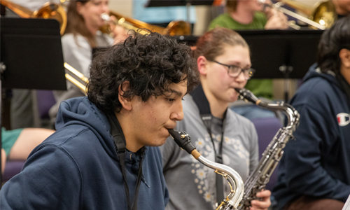 YVC student playing saxaphone during a music class. 