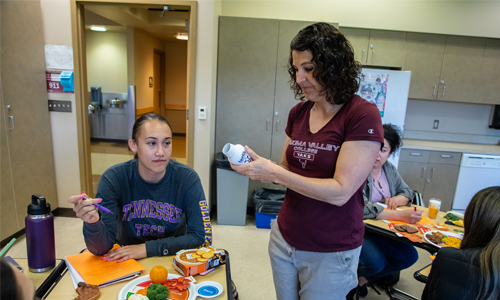 YVC instructor works with student in a nutrition class. 