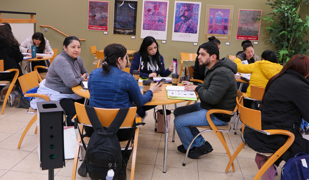 YVC Students work at a round table in a YVC common area. 