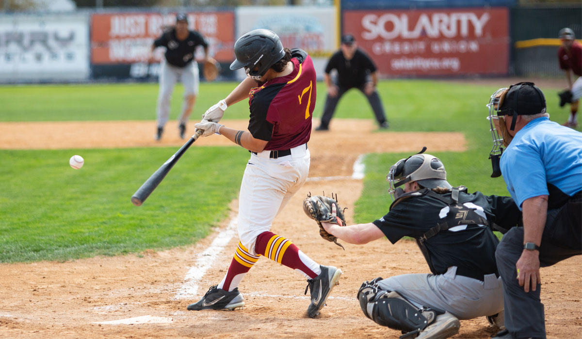 A batter is pictured about to hit the baseball. 