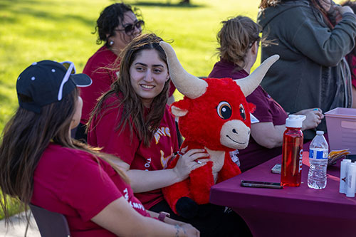 Two students talking during YVC event dressed in YVC gear. 