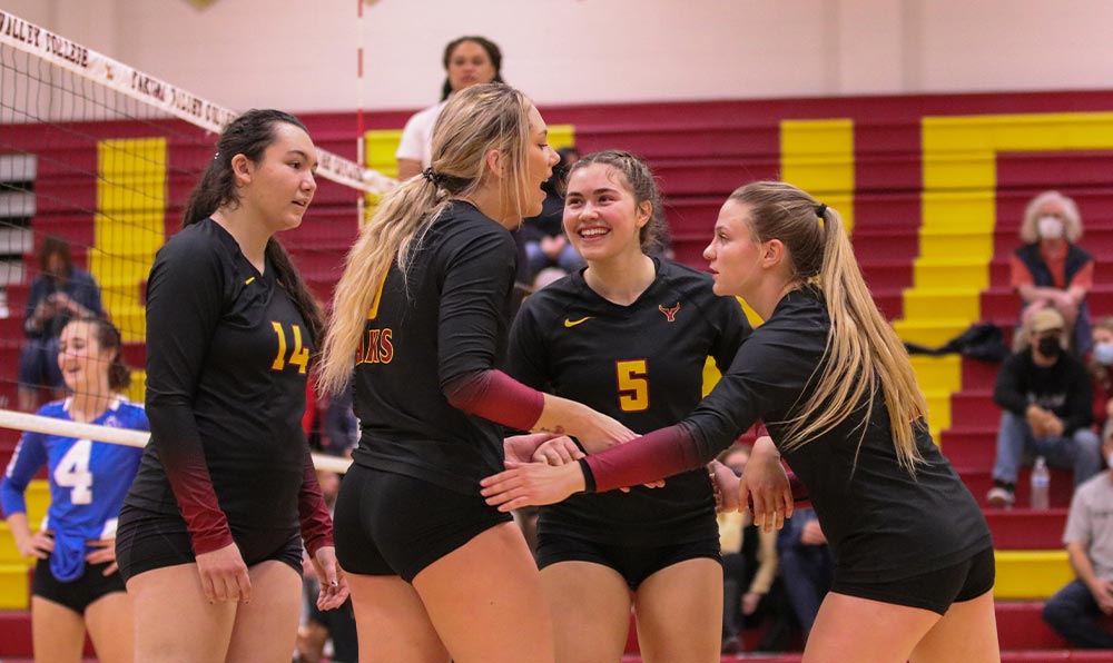 Female volleyball players celebrate