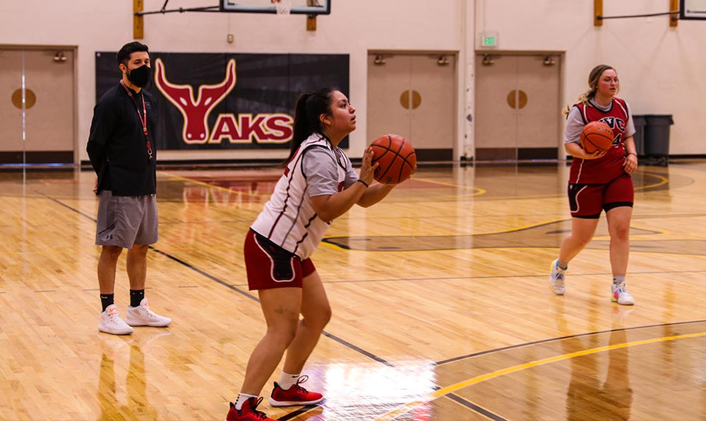 Female basketball player with coach