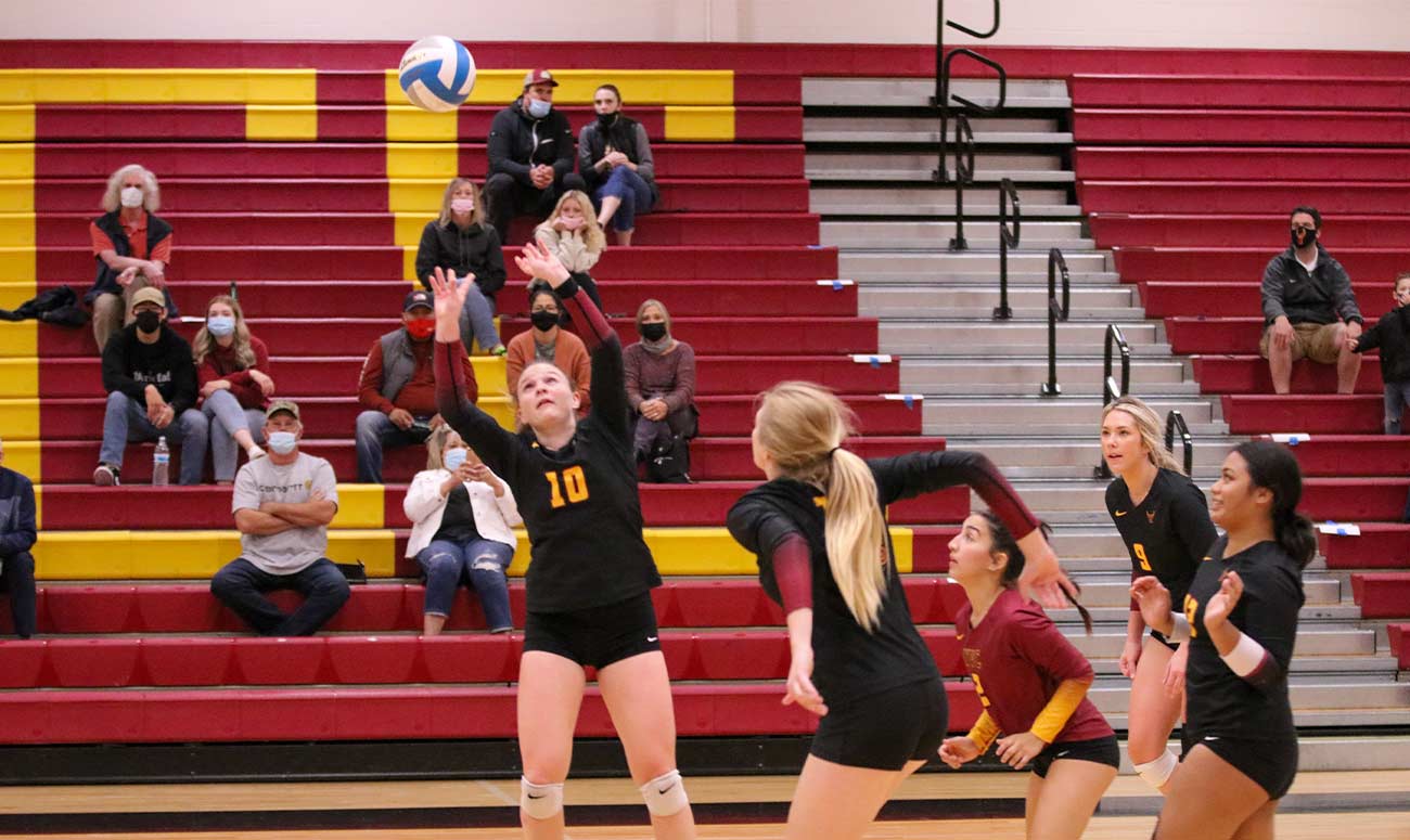 Female volleyball player sets for a spike