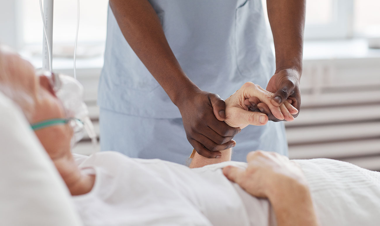 Male nurse helping a patient