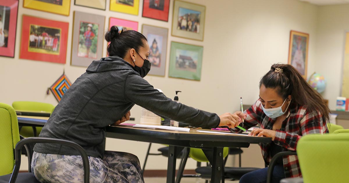 Students doing homework at table