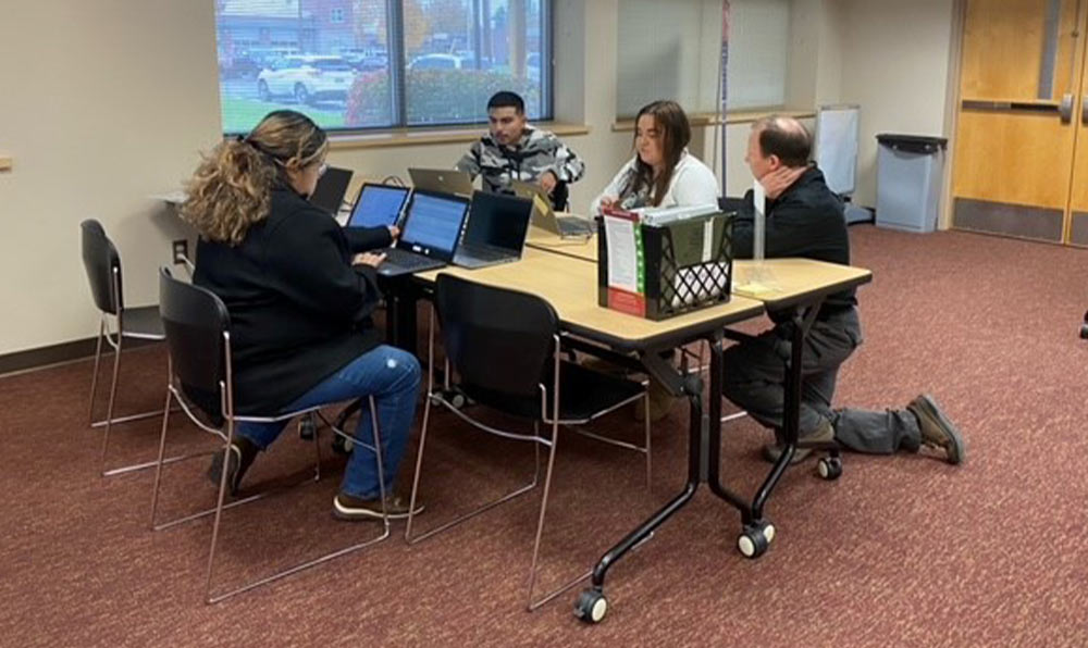 College students and faculty at table