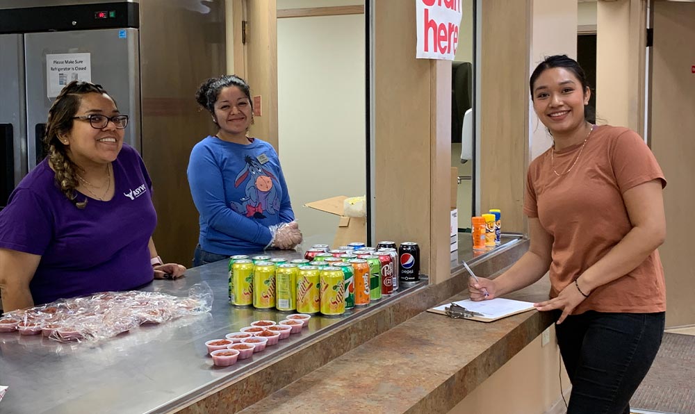 Students stand at counter