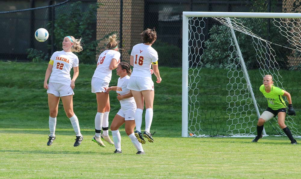 Female soccer players in defensive wall