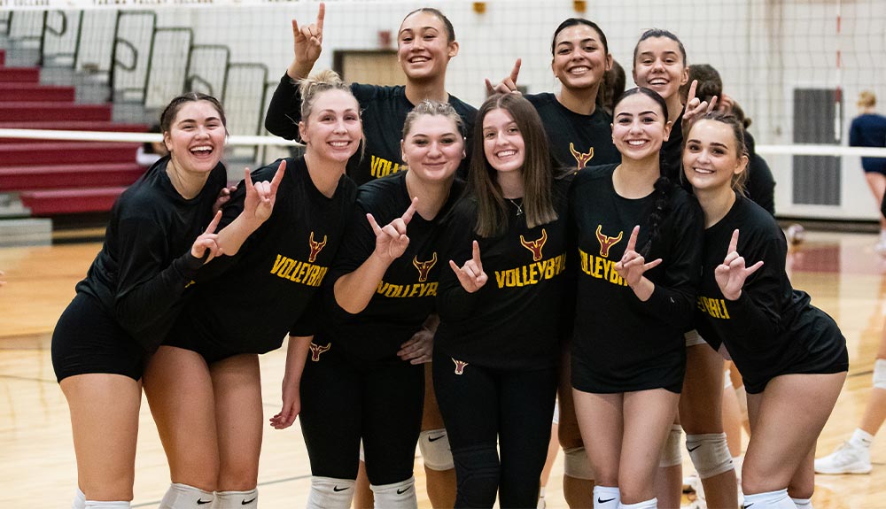 Female volleyball players pose