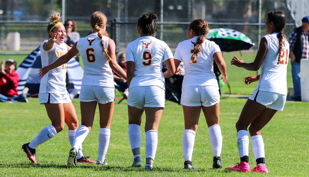 Female soccer players celebrate