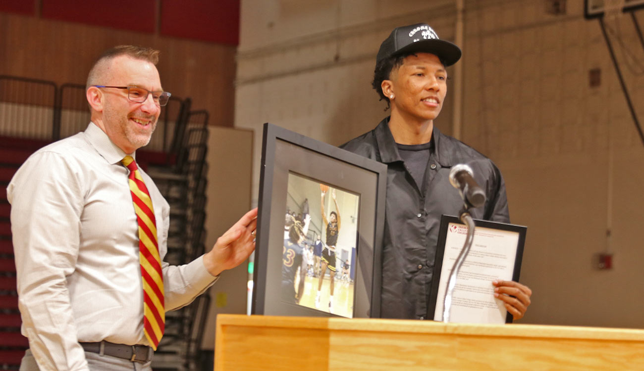 Alumnus basketball player and athletics director at podium