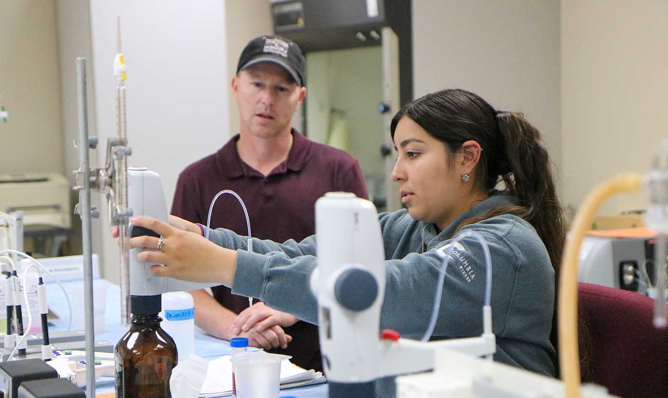 Student works with instructor Trent Ball