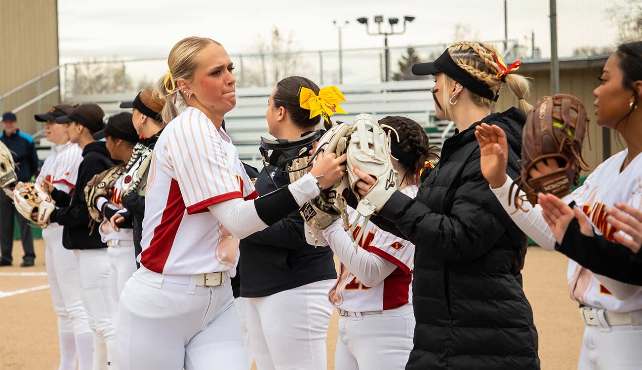 Softball player with teammates