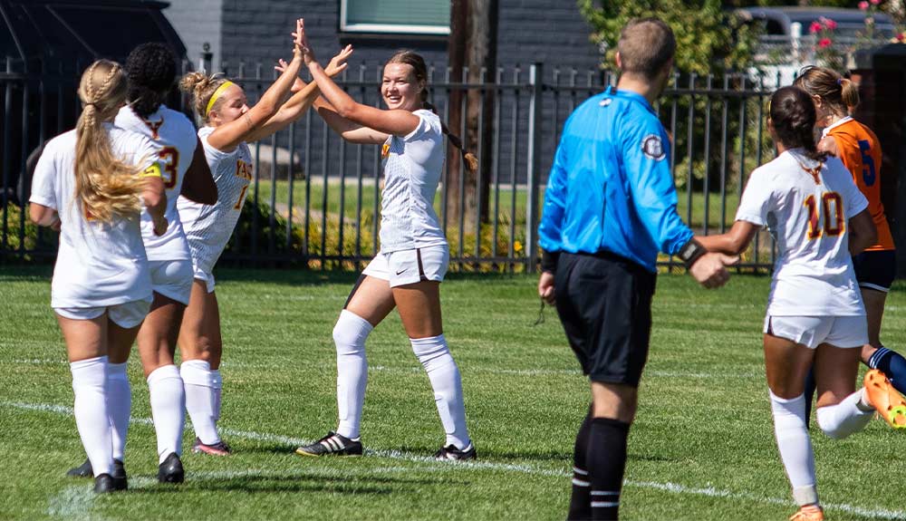 Women's soccer players celebrate