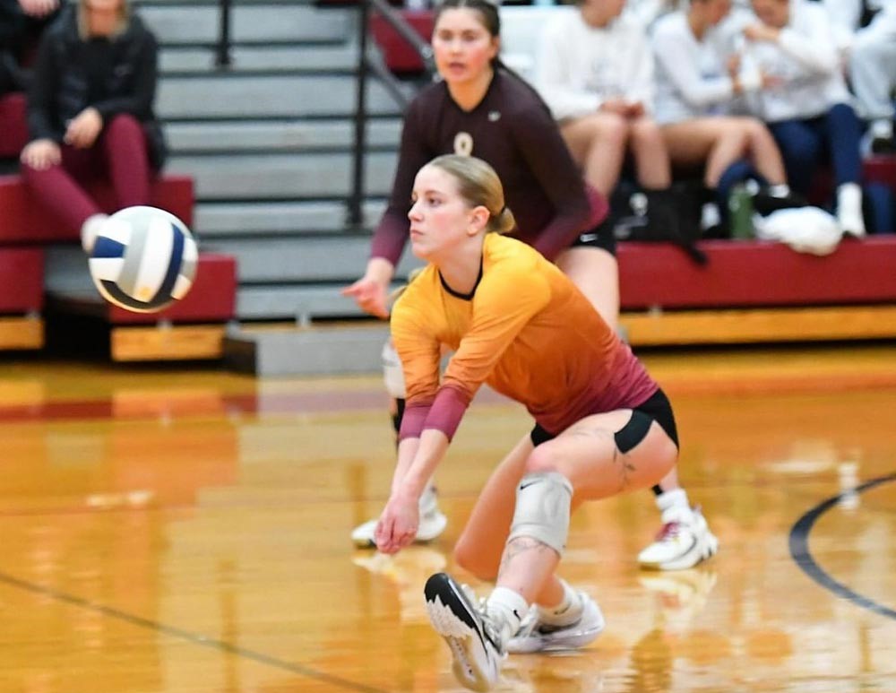 Volleyball player digs ball