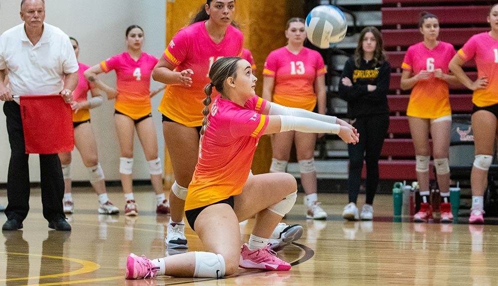 Volleyball player digs ball