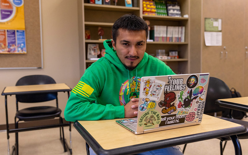 YVC student Guillermo Verdin sitting at desk with laptop