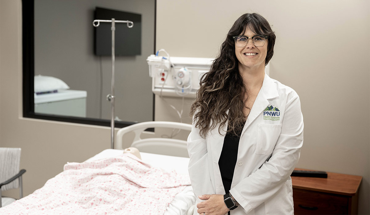 YVC alumna Vanessa Soto standing beside hospital bed