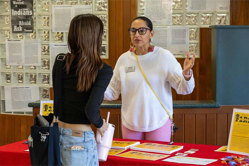 YVC staff member talks to student about first-generation student pledge