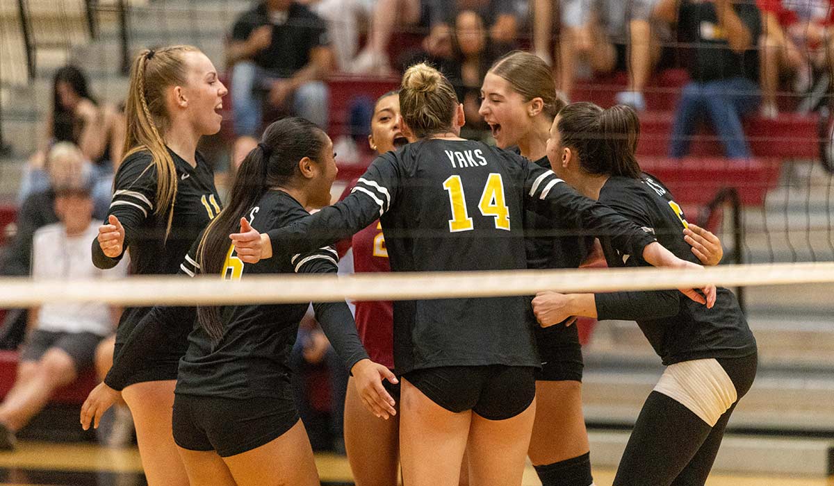 Yakima Valley College volleyball players celebrate after earning a point