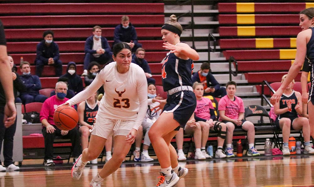 Female basketball player dribbling