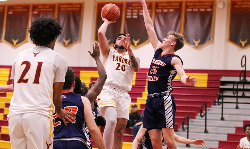 Male basketball player takes shot