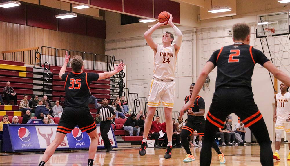 Men's basketball player attempts jump shot