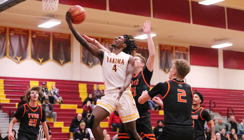 Men's basketball player drives for layup