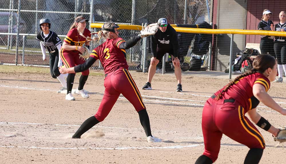 Softball pitcher winds up for pitch