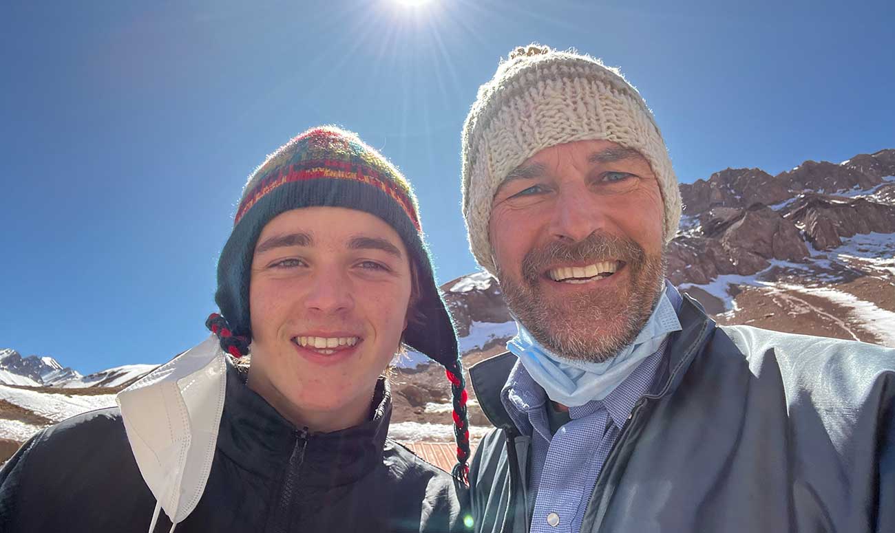 Posing for picture with son on the mountain. 