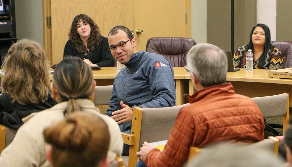 Man speaks others in a conference room