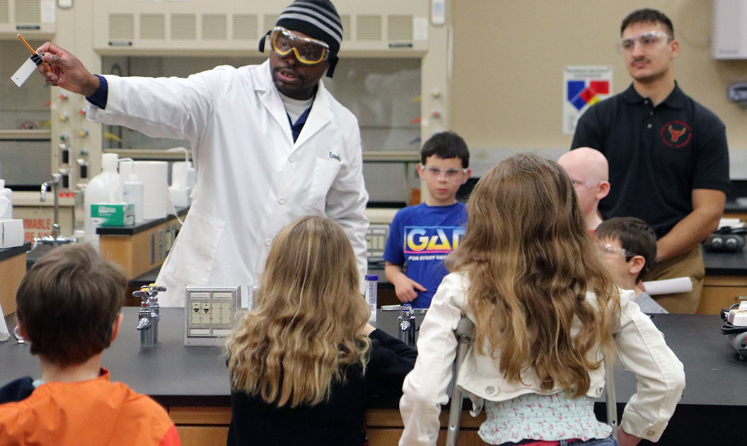 Emeka Udenze shows students an experiment