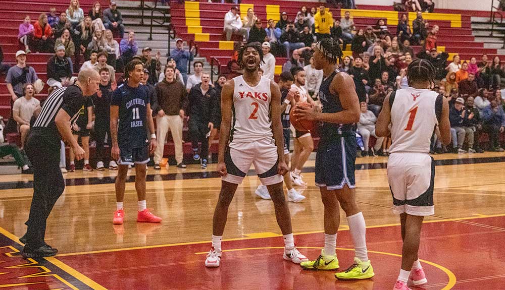 Male basketball player celebrates after scoring