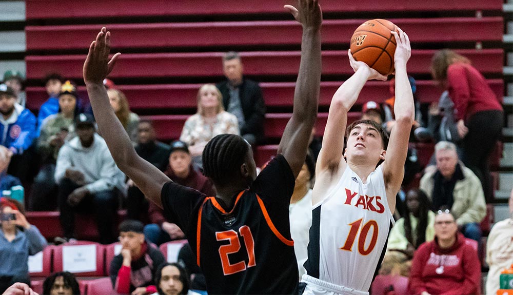 Male basketball player takes fadeaway jump shot