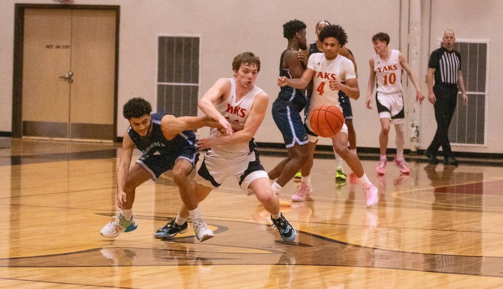 Male basketball player forces turnover.