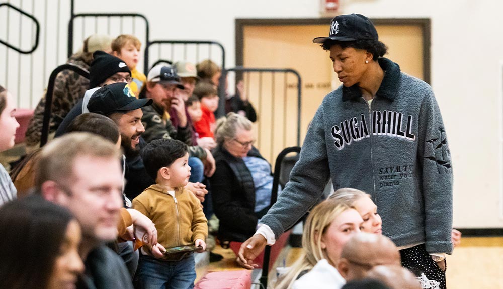 Former basketball player talks to fans in stands