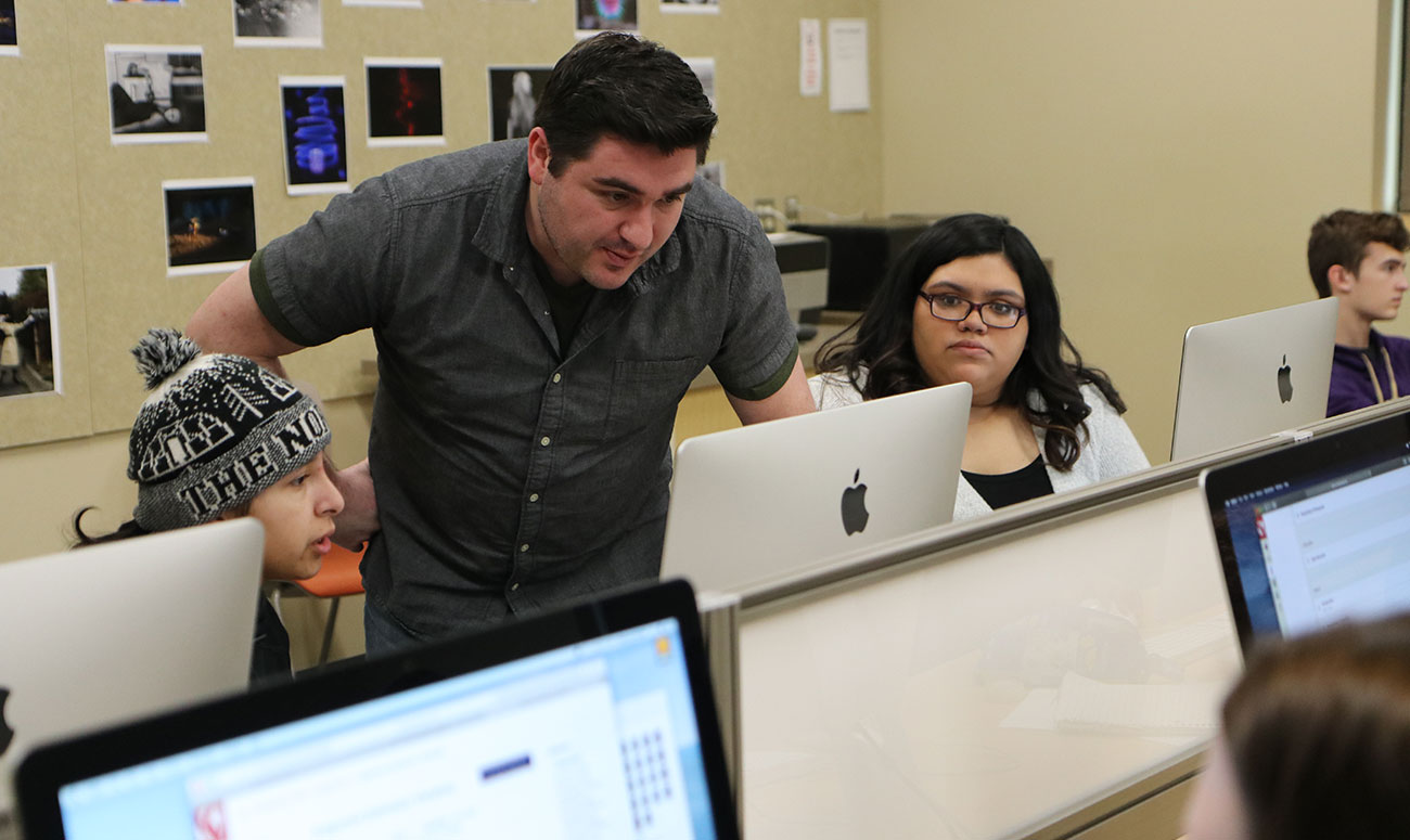 Photography Instructor Chris Otten reviews a students photo during class.