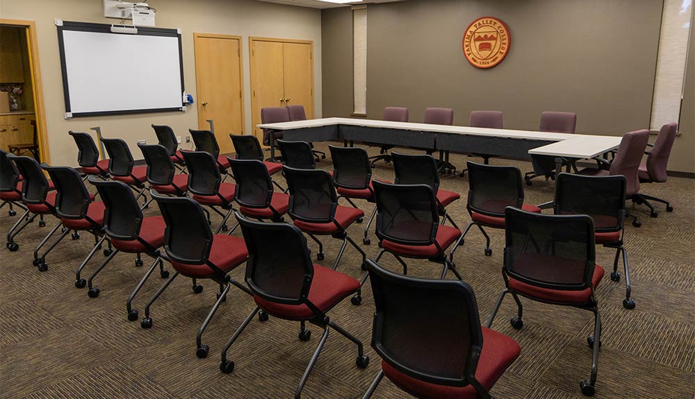 Chairs on wheels in front of table in YVC's Hopf Union Building