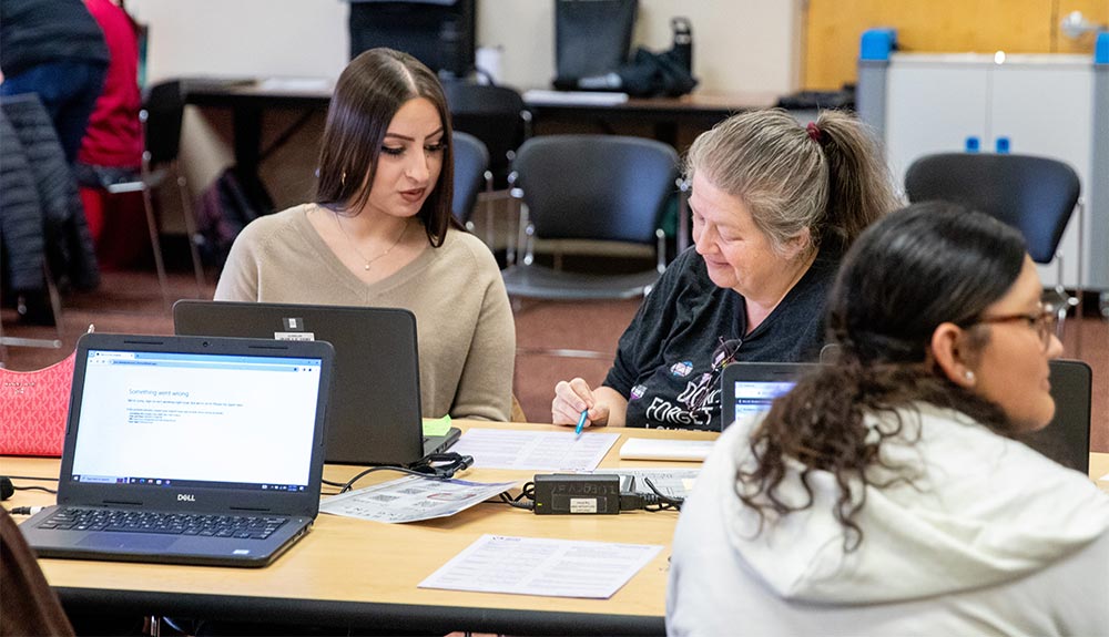 Female instructor talks to female student for academic advising