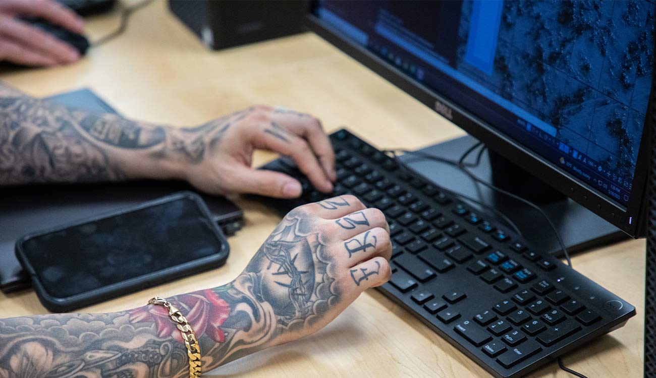 Hands typing on computer keyboard