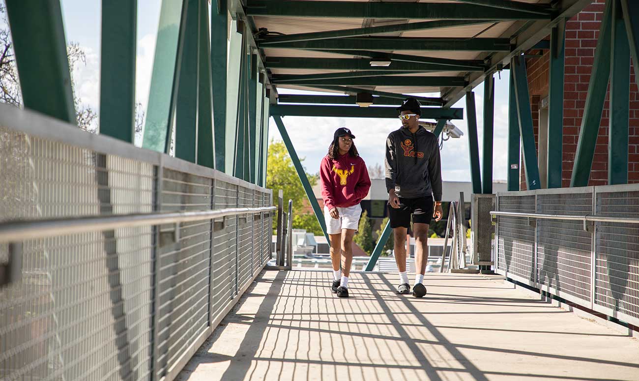 Students walk across the pedestrian bridge on YVC's Yakima Campus