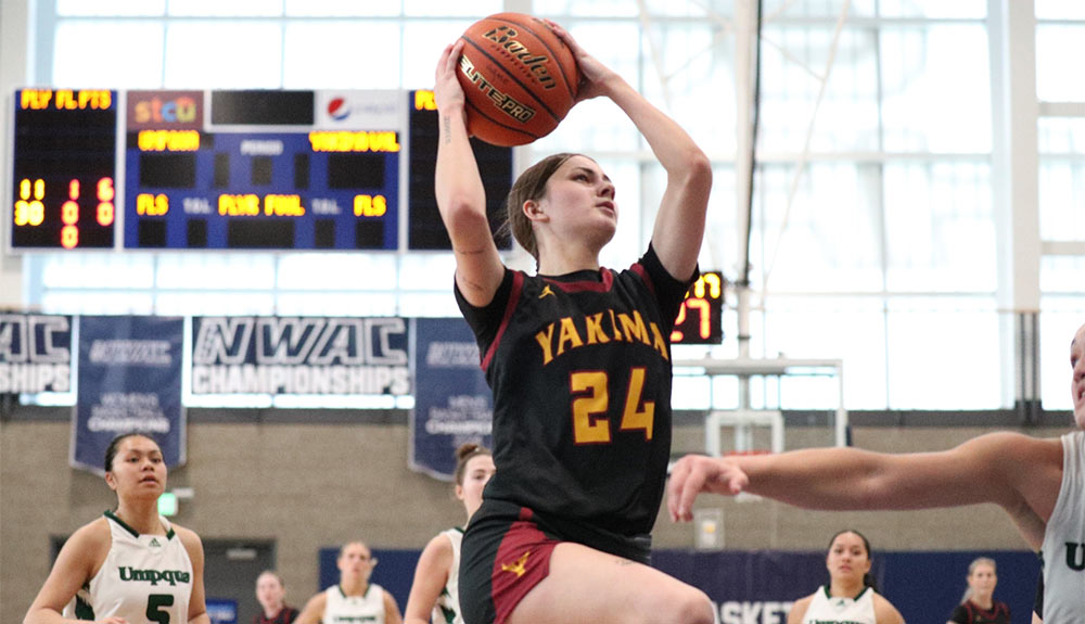 Female basketball player attempts layup