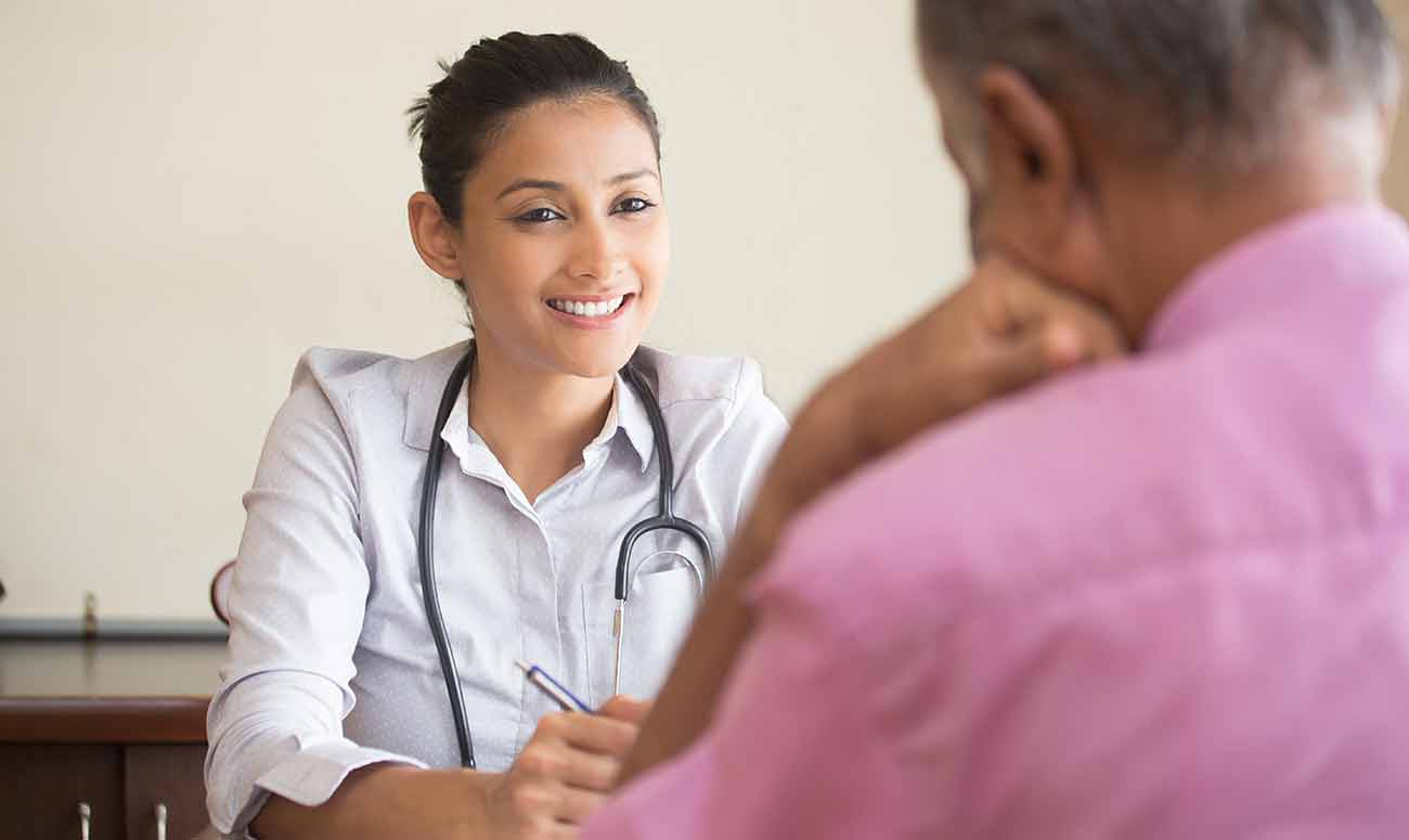 Spanish medical professional talks with patient