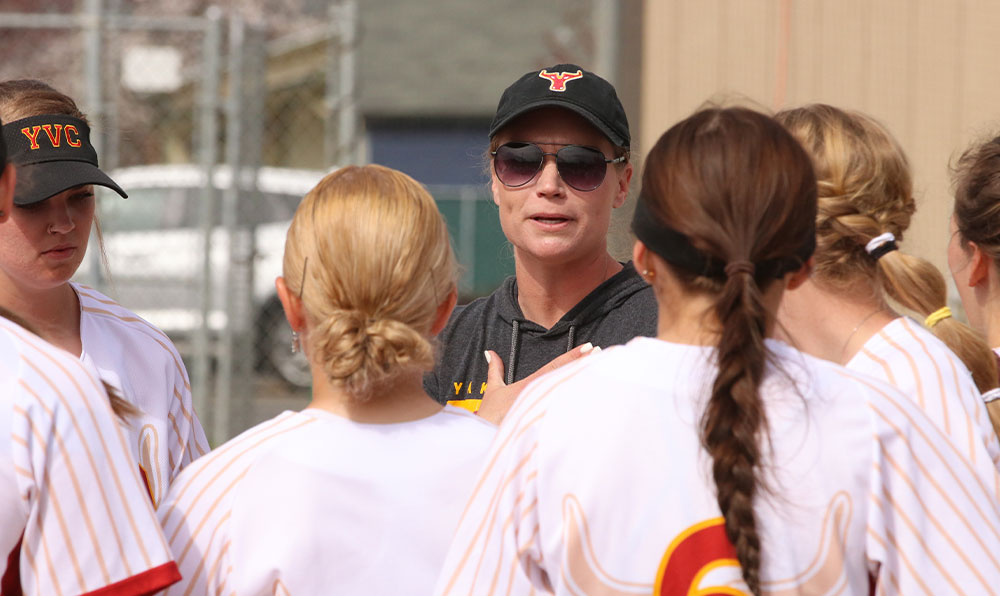 Softball coach talks to players