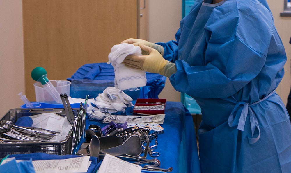 Surgical technician with tray of surgical instruments