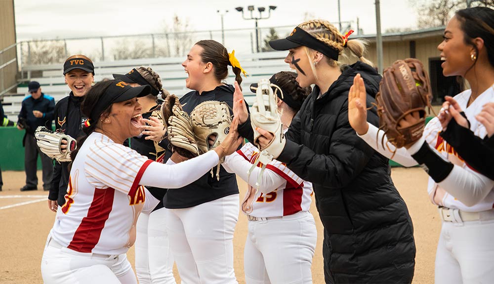 Softball players celebrate