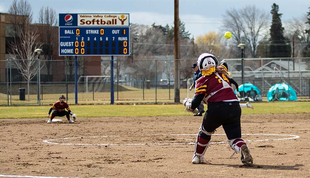 Softball catcher makes throw to second base