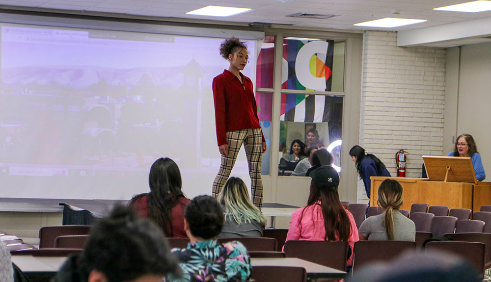 Student poses during fashion show